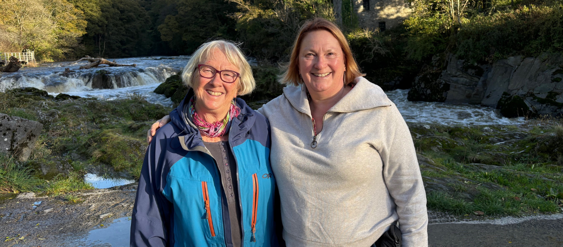 Natalie on the left and sister, Bridget, on the right. Smiling in front of waterfalls.