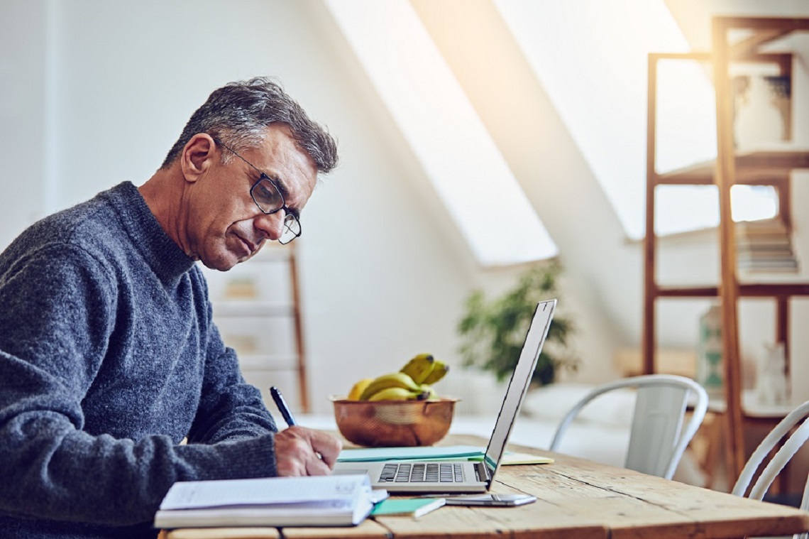 Man writing at desk